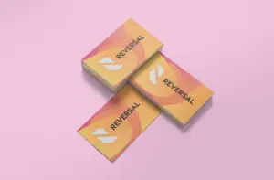 "Mockup of a business card with a bold and vibrant design featuring shades of pink and orange. The card includes company contact information such as name, phone number, and email address, all of which are easy to read against the bright background."